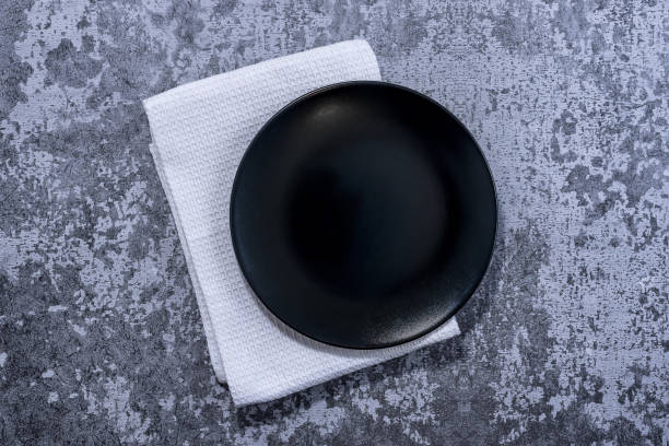 istock Black plate, cutlery and napkin 1290384016