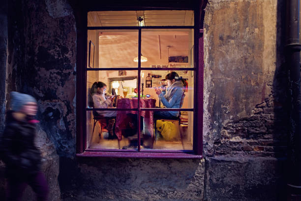 istock Girlfriends are sitting and texting in a cafe 1290387789