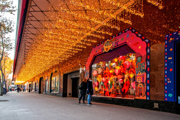 Covid-19 : Few peoples in front of Galeries Lafayette department store windows during lockdown. At Christmas approaches, there are usually crowded. Paris, boulevard Haussmann, in France. November 27, 2020.