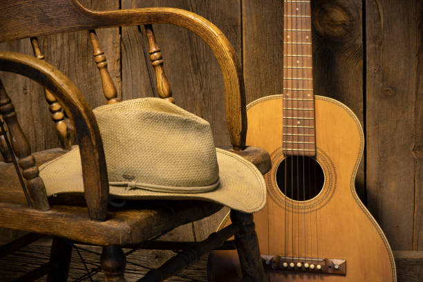 istock Partial saloon chair and cowboy hat with guitar 1290388857