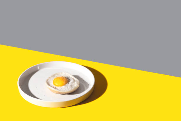 Fried egg on a white plate Color of the year 2021