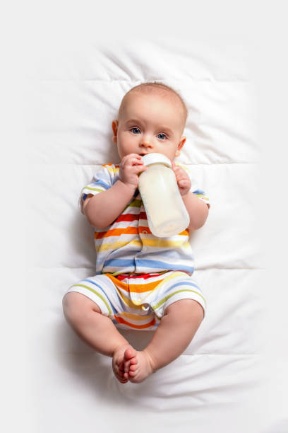 istock Baby with baby milk bottle. Top view. 1290394845