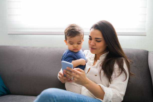 istock Mother and son using smart phone at home 1290398086