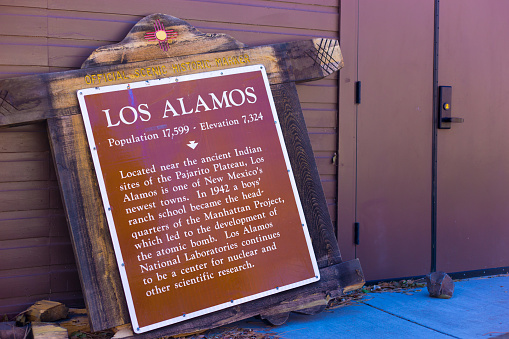 Los Alamos, NM: Vintage wooden tourist information sign outside museum in downtown Los Alamos, a town made famous as the 1940s home of the Manhattan Project.