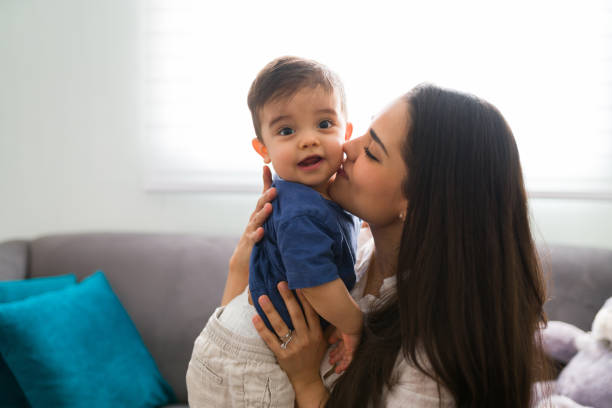 istock Young mother kissing her son 1290398135