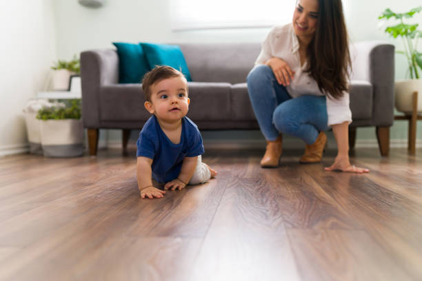 istock Baby enjoying crawling in living room 1290398443