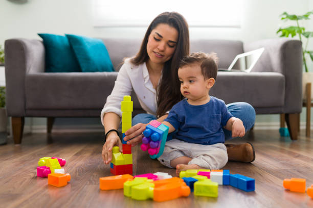 istock Mom and child playing blocks at home 1290398597
