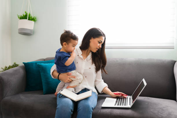 istock Single mother with baby working from home 1290398672
