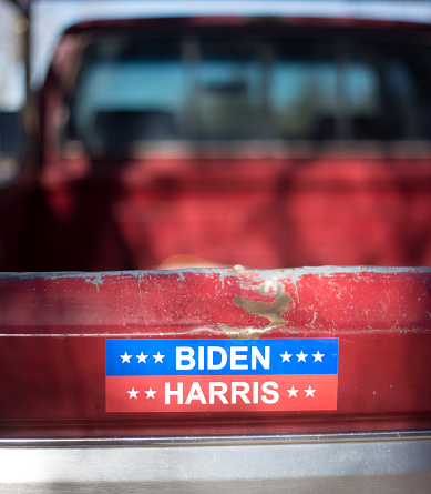 Santa Fe, NM: A 2020 political bumper sticker on an old red pick-up truck. Close-up shot.