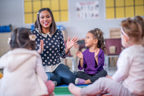istock Group of kindergarten children singing and smiling 1290411349