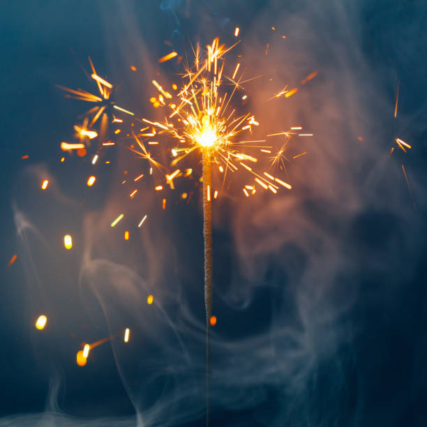 istock fire sparkler in dense smoke, abstract Christmas firework background 1290412733