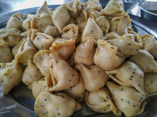 istock Singaras before frying on an aluminium bowl. 1290413066