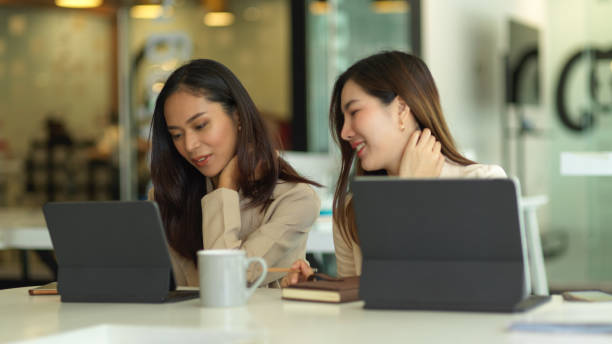 istock Two female office workers consulting on their project with digital tablets in meeting room 1290414703