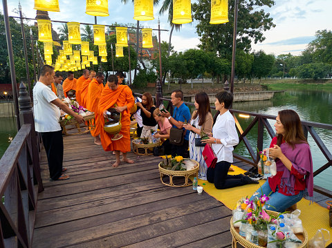 Wat Traphang Thong, SUKHOTHAI THAILAND-27 November 2020:Activities to make merit for Sukhothai in the morning In the middle of the bridge over the water is a favorite activity for tourists.