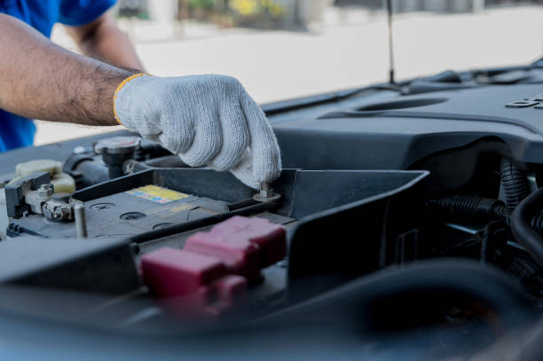 istock A young Asian auto mechanic opens the bonnet. To check for engine damage And perform professional maintenance. He wearing blue uniform. 1290419427