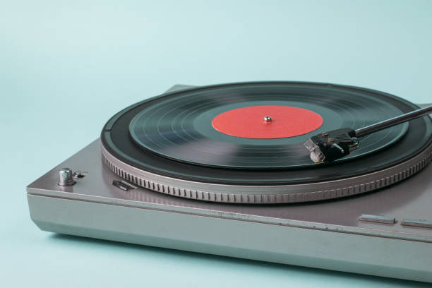 istock Vinyl record player with a red disc on a blue background. 1290421088