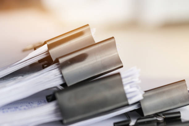 istock Stack of Paper documents with clip, Pile of unfinished documents on office desk folders. Business papers for Annual Report files, Document is written,presented. Business offices concept. 1290423516