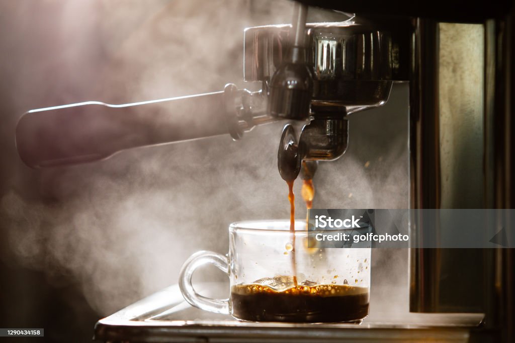 Espresso machine Barista brewing the espresso coffee by using high pressured espresso machine in a small coffee shop. Coffee machinery in coffee shop. Drinking Stock Photo