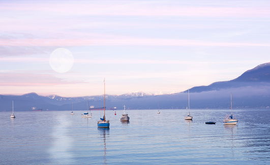 Moonset and sunrise in Kits Beach, Vancouver, BC