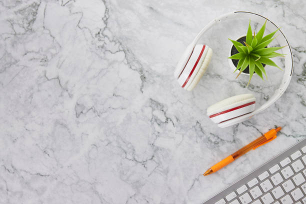 istock Modern Clean Top View Office Desk or Table and Headphone on Marble Background 1290437139