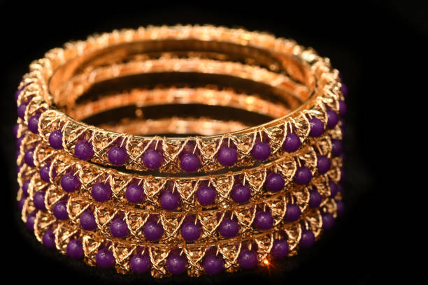 istock Fancy Designer Bracelets Bangles Jewelry closeup Macro image on Black Background 1290443660