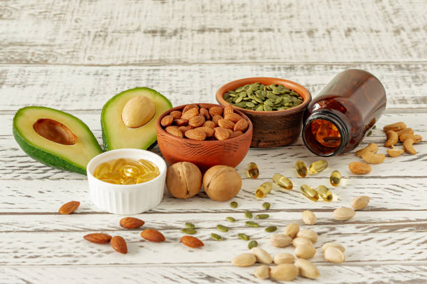 vegetable sources of omega-3 acids. balanced diet concept. avocado, nuts, oils on wooden background - nutritional supplement salmon food flax imagens e fotografias de stock
