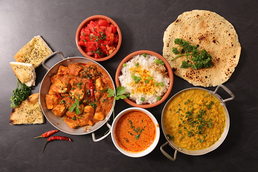 assorted of indian dish with curry dish, naan,  chicken
