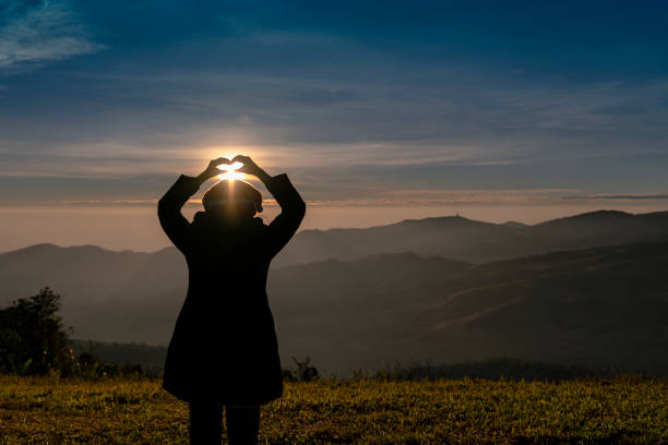 istock silhouette woman on sunrise hill 1290448340