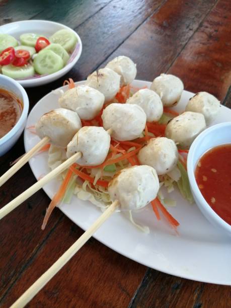 istock Skewered meatballs in a white plate with dipping sauce 1290451310