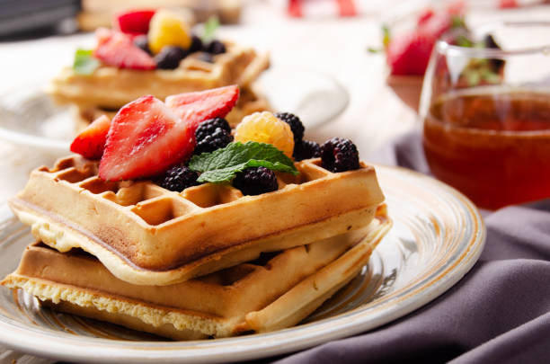 istock CLoseup view at belgian waffles served with strawberries and blackberries on kitchen table 1290451337
