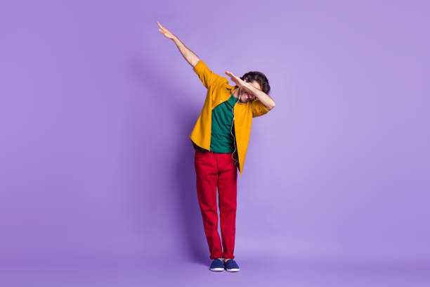 Photo portrait full body view of guy dabbing isolated on vivid purple colored background Photo portrait full body view of guy dabbing isolated on vivid purple colored background. dab dance photos stock pictures, royalty-free photos & images