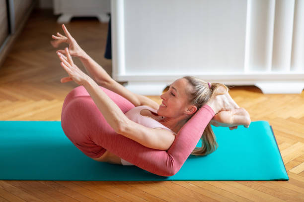 istock Woman in Yoganidrasana stretching arms forward 1290453785