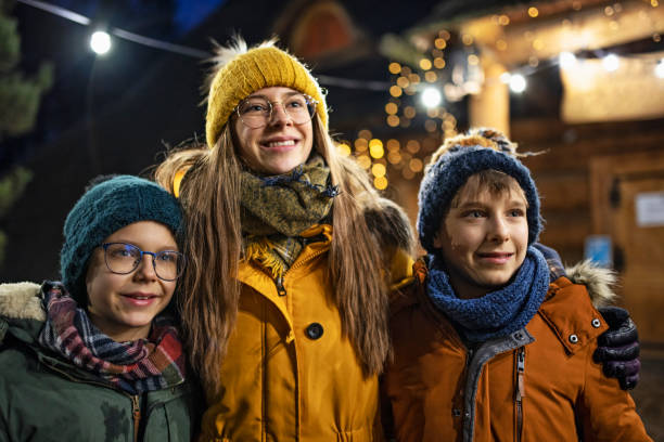 istock Kids in Christmas decorated small town 1290453880