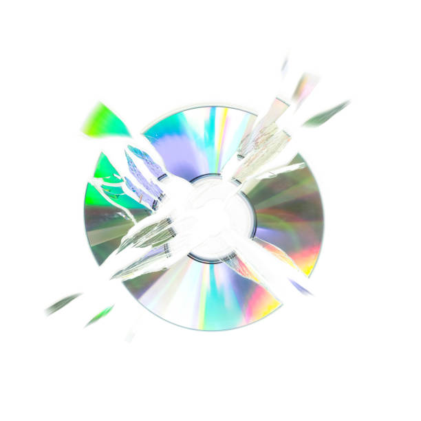 The CD shatters into pieces. Close up. Isolated on a white background.