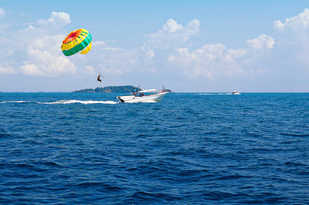 Water sports using a speedboat Speedboat and umbrella sports in the sea parasailing stock pictures, royalty-free photos & images