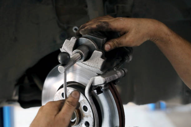 istock Brake pad replacement in car service 1290457999