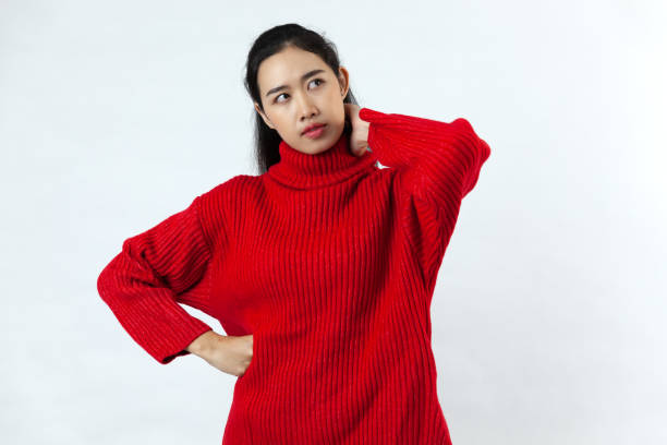 istock Asian girl wearing red sweater standing on white background 1290458020