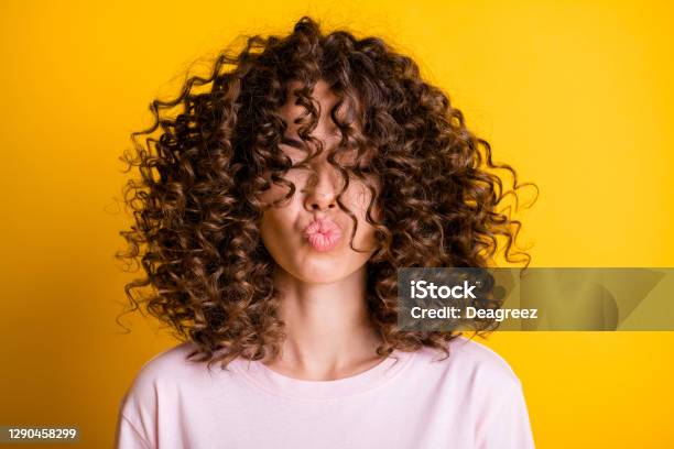 Headshot Of Girl With Curly Hairstyle Wearing Tshirt Send Air Kiss Pouted Lips Isolated On Vivid Yellow Color Background Stock Photo - Download Image Now
