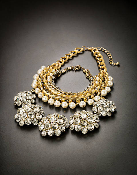 istock Pearl gold necklace on gray background 1290459714