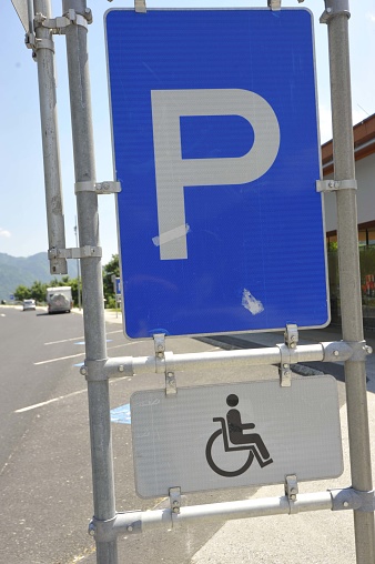 Freshly painted handicap parking sign in Shopping mall lot.