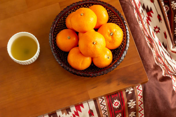 Tea and mandarin oranges placed on the kotatsu stock photo