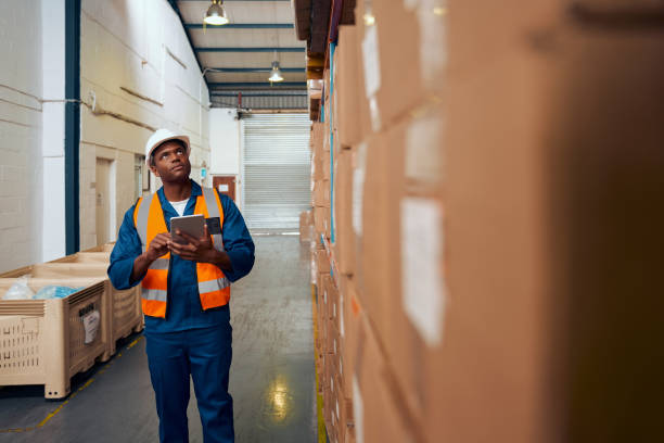 istock African American factory worker checking stock inventory using digital tablet in modern warehouse 1290460818