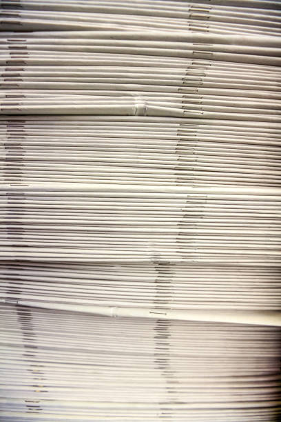 istock Vertical shot of stacked newspapers on the table 1290460821
