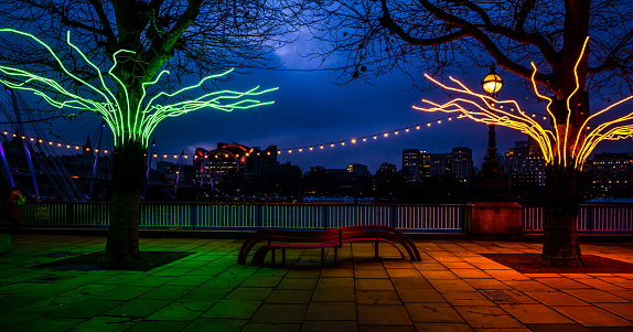 in London at Tames promenade, colored lights shine on the trees