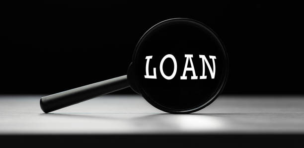 istock Magnifying glass with the word loan on table. Search idea 1290461045