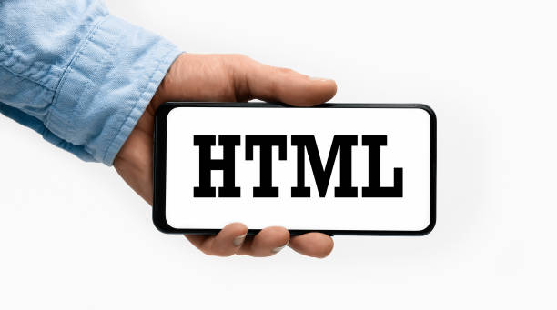istock Closeup of a male hand holding Smartphone with word Html on display 1290461053