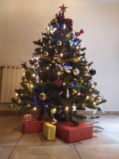 istock nice christmas tree with decorations and gifts 1290463108