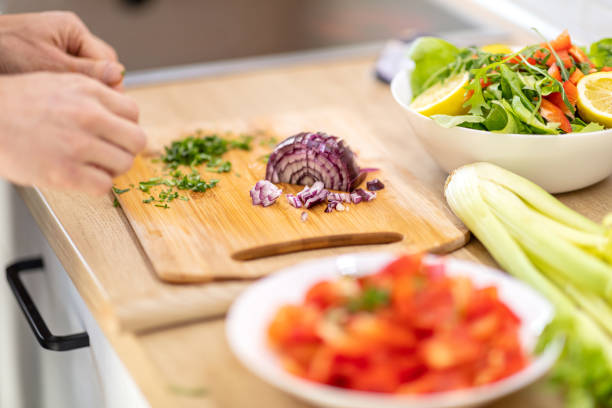 istock Making fresh organic salad with chopped onion 1290464247