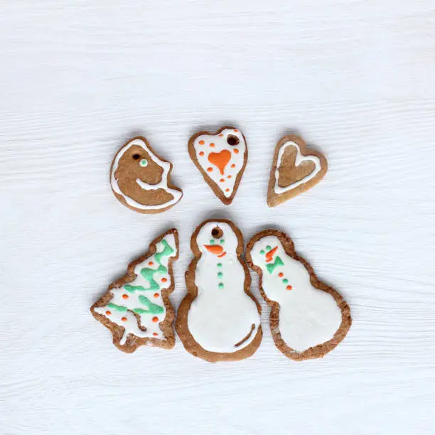 pair of snowmen, a Christmas tree, a month and two hearts from gingerbread glazed cookies