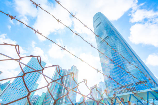 istock Cityscape outside barbed wire fence 1290469282